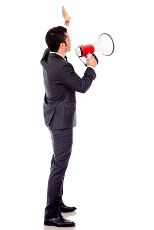 Businessman speaking loud through a megaphone - isolated over a white backround